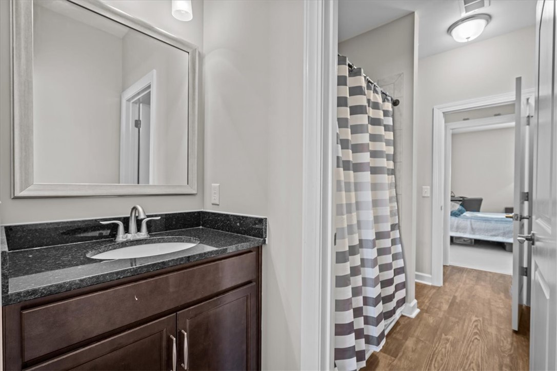 324 Crestgate Way Easley, SC 29642 - Photo 27 of 44 This bright bathroom features a vanity with granite counters and rich wood-toned cabinetry.