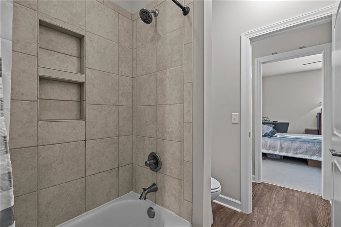 324 Crestgate Way Easley, SC 29642 - Photo 33 of 44 This bathroom features a sleek tub and shower combination with stylish tile accents and durable flooring.