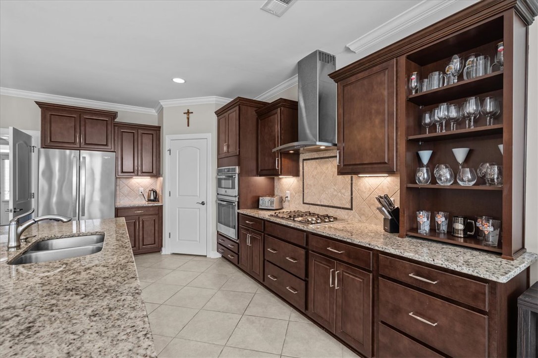 324 Crestgate Way Easley, SC 29642 - Photo 9 of 44 This kitchen features rich wood cabinetry, ample counter space, and modern appliances for daily living.