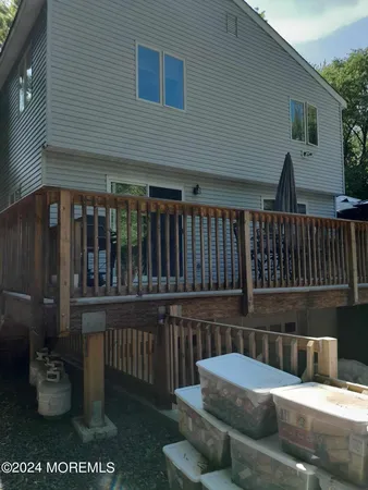 a balcony with furniture and wooden floor