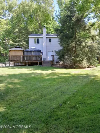 a view of a house with a yard and sitting area