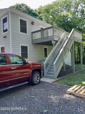 a view of a house with a yard and sitting area