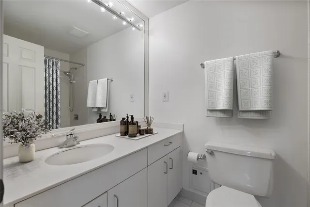 a bathroom with a sink toilet and mirror