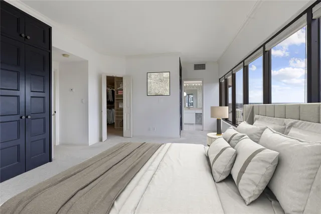 a bedroom with a large bed and a couch