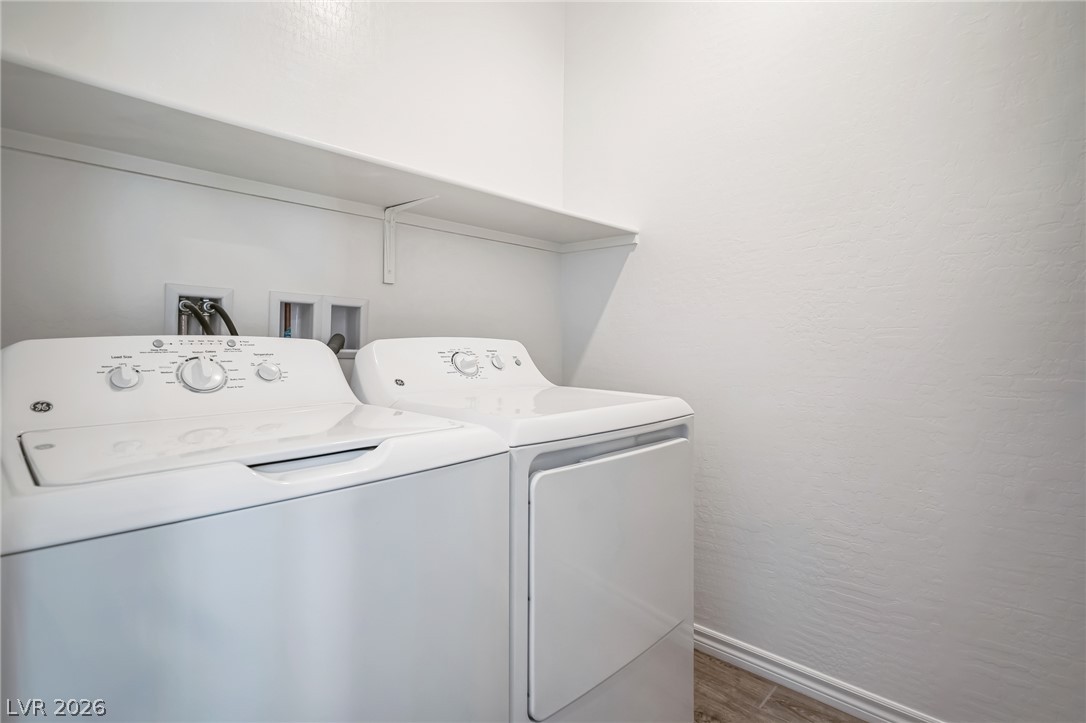 7348 North Decatur Boulevard, Unit 1 North Las Vegas, NV 89084 - Photo 15 of 17 Functional laundry space featuring modern appliances and a convenient overhead shelf.