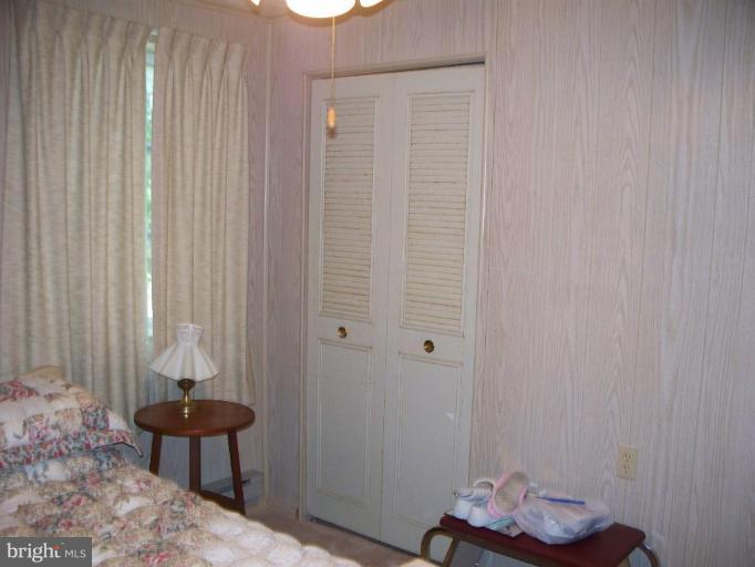 2818 Tabor Road Berkeley Springs, WV 25411 - Photo 5 of 21 a bedroom with a bed and a chair