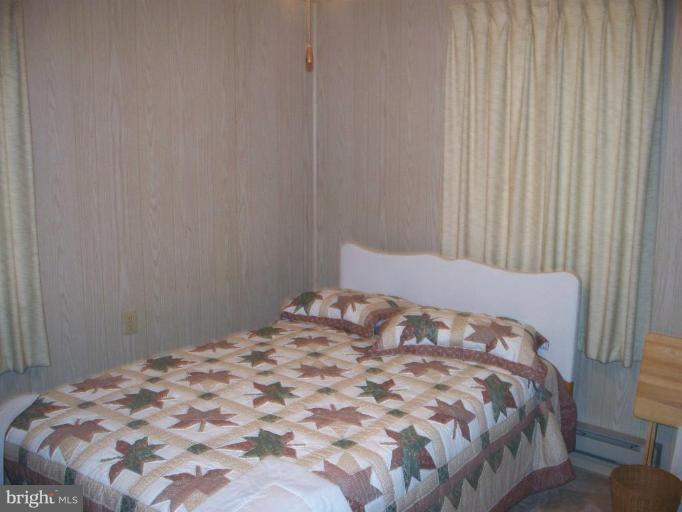 2818 Tabor Road Berkeley Springs, WV 25411 - Photo 6 of 21 a bedroom with a bed and curtain