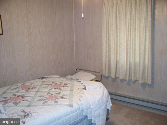 2818 Tabor Road Berkeley Springs, WV 25411 - Photo 7 of 21 a bedroom with a bed and a window