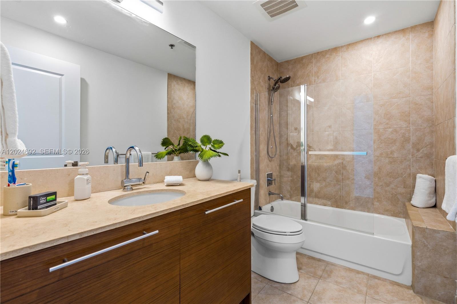 2641 North Flamingo Road, Unit 2605N Sunrise, FL 33323 - Photo 15 of 56 a bathroom with a granite countertop sink toilet and shower