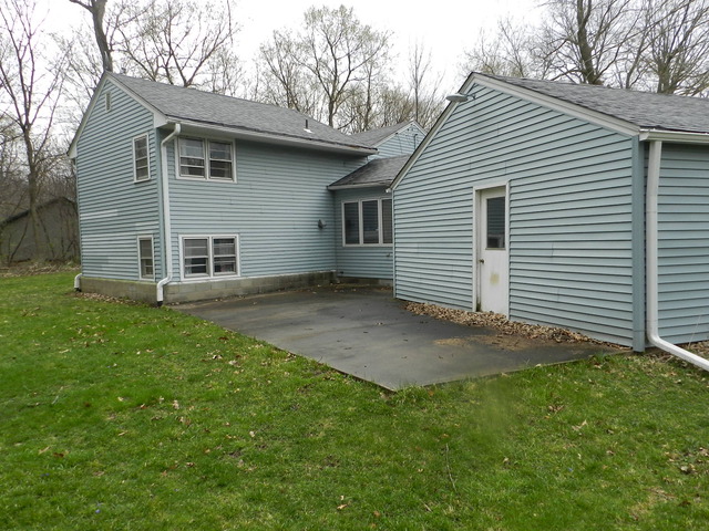 7014 East McCormick Road Stillman Valley, IL 61084 - Photo 12 of 13 a view of a backyard with a garden
