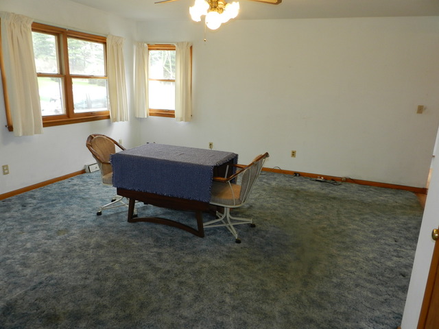 7014 East McCormick Road Stillman Valley, IL 61084 - Photo 5 of 13 a wooden bench sitting in a room next to a window