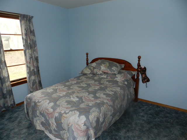 7014 East McCormick Road Stillman Valley, IL 61084 - Photo 6 of 13 a bed sitting in a bedroom next to a window