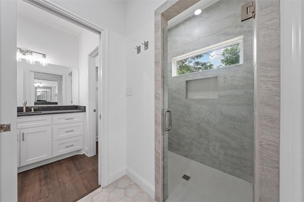 1698 Rogers Hill Road Waco, TX 76705 - Photo 25 of 40 Bathroom featuring a shower stall, vanity, baseboards, and tile patterned flooring