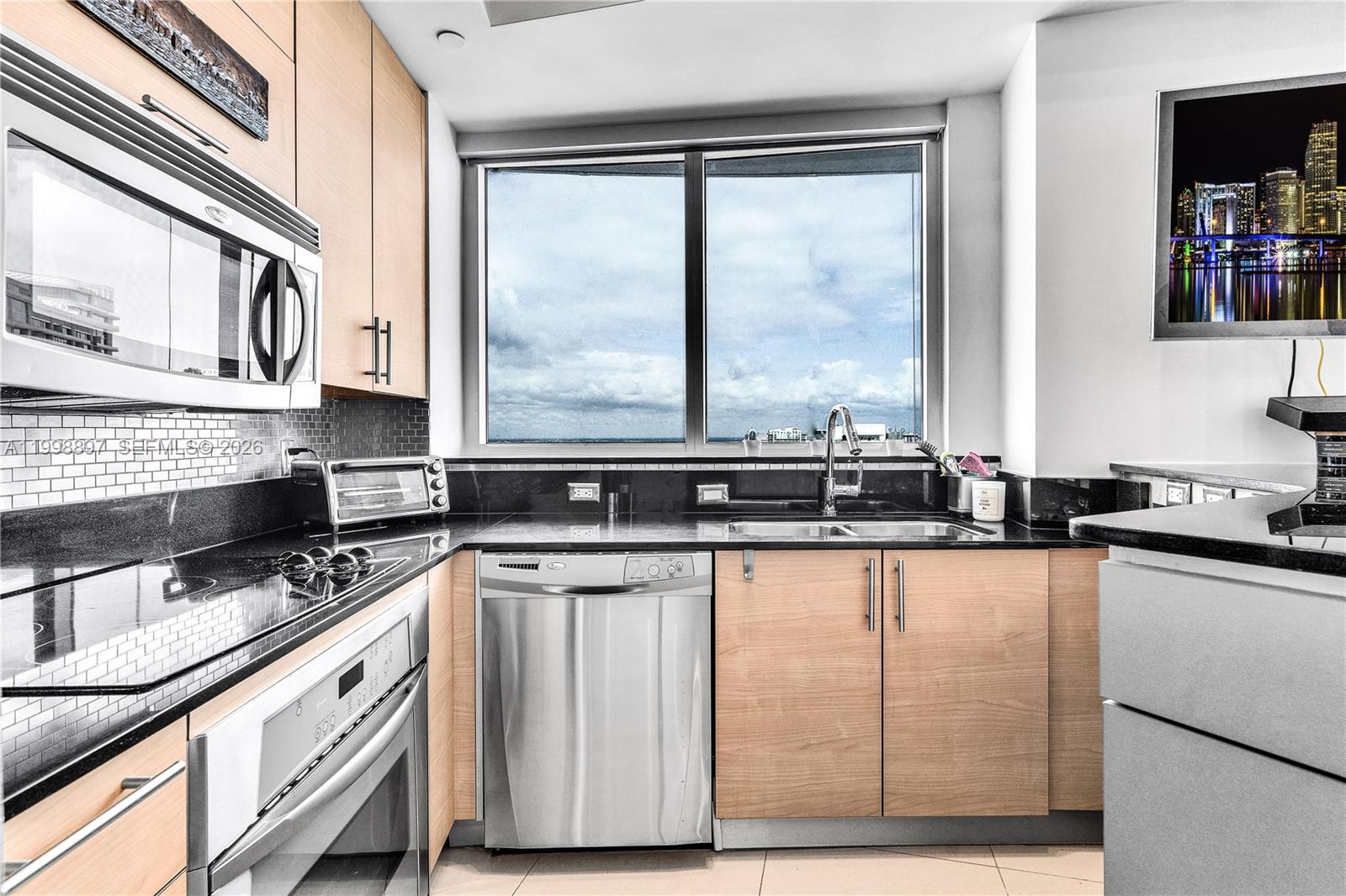 60 Southwest 13th Street, Unit 4818 Miami, FL 33130 - Photo 11 of 19 a kitchen with stainless steel appliances granite countertop a sink and a counter space