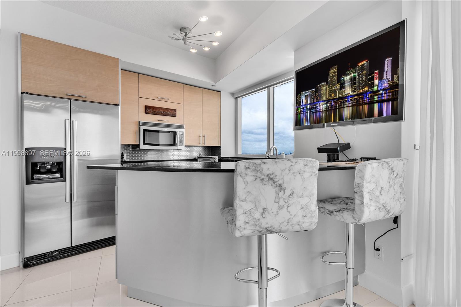 60 Southwest 13th Street, Unit 4818 Miami, FL 33130 - Photo 12 of 19 a kitchen with stainless steel appliances granite countertop a refrigerator and a sink