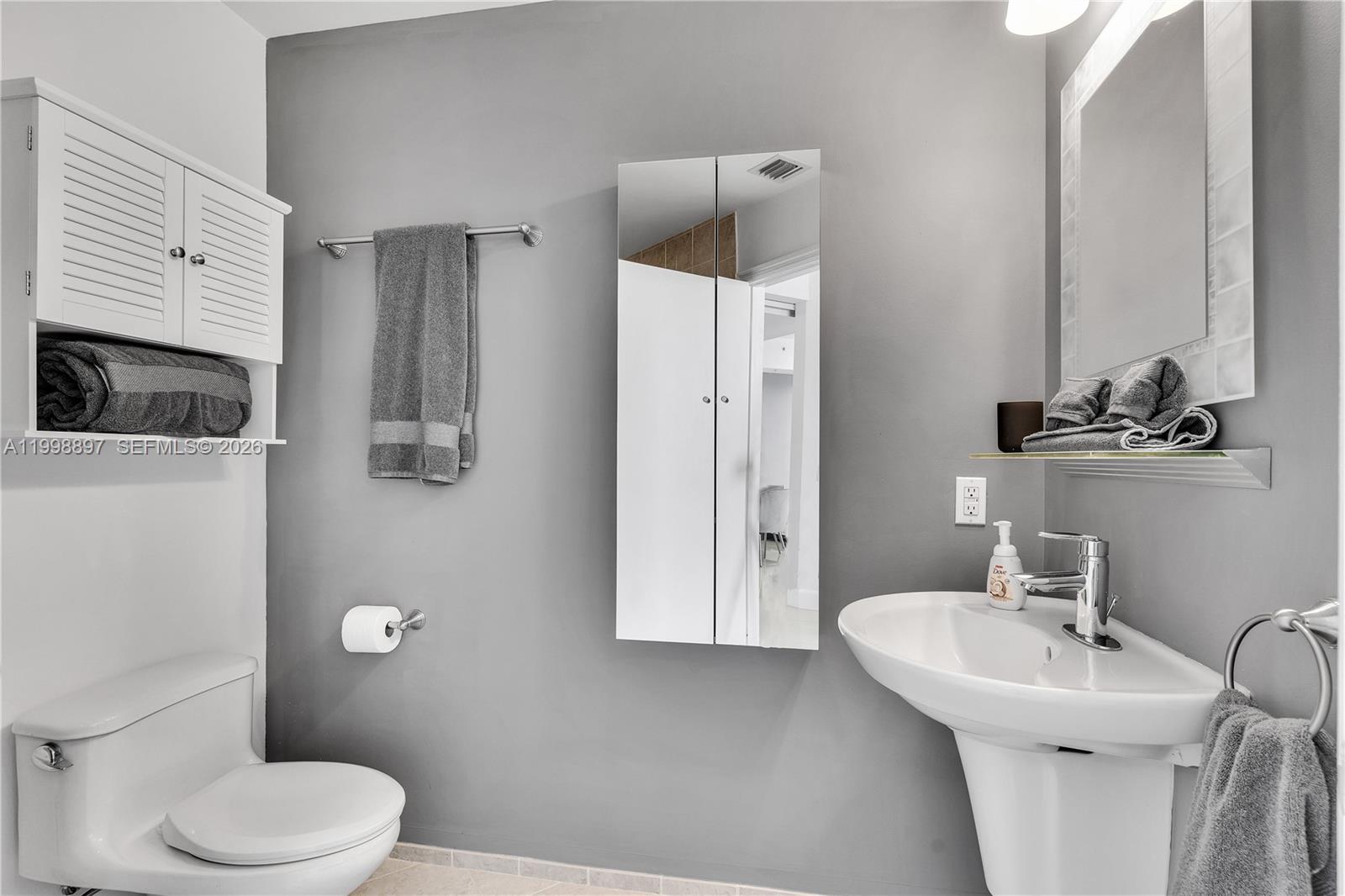 60 Southwest 13th Street, Unit 4818 Miami, FL 33130 - Photo 15 of 19 a bathroom with a toilet sink and shower