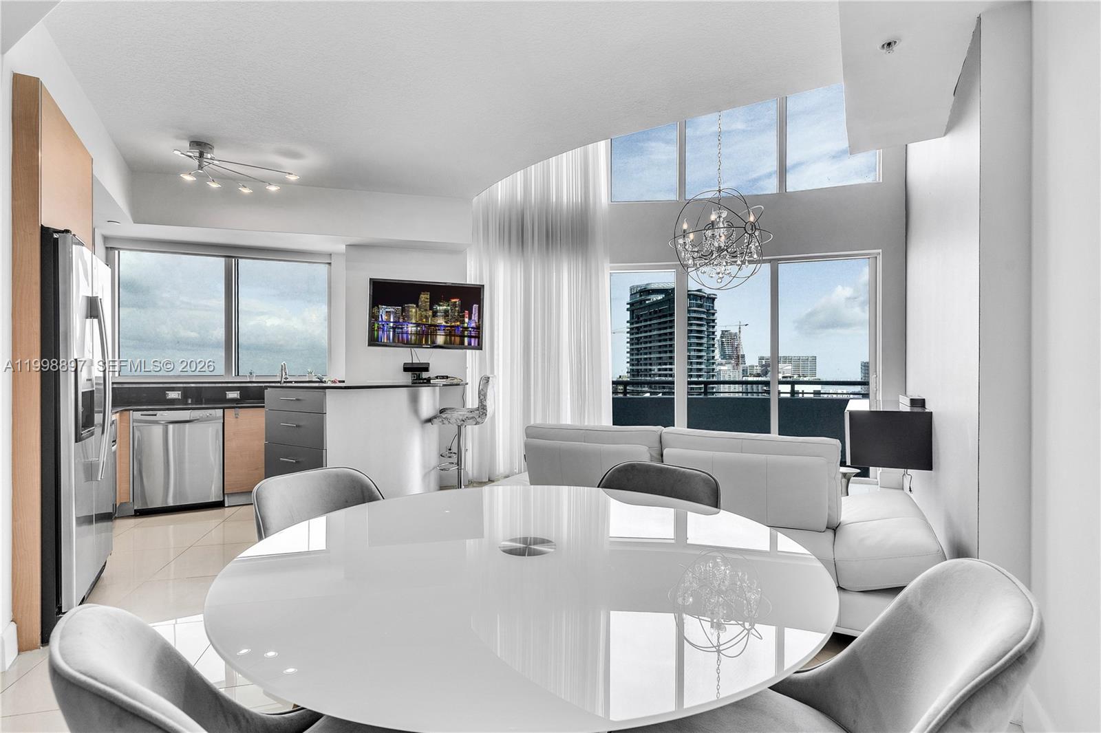 60 Southwest 13th Street, Unit 4818 Miami, FL 33130 - Photo 6 of 19 a large white kitchen with a large window and stainless steel appliances