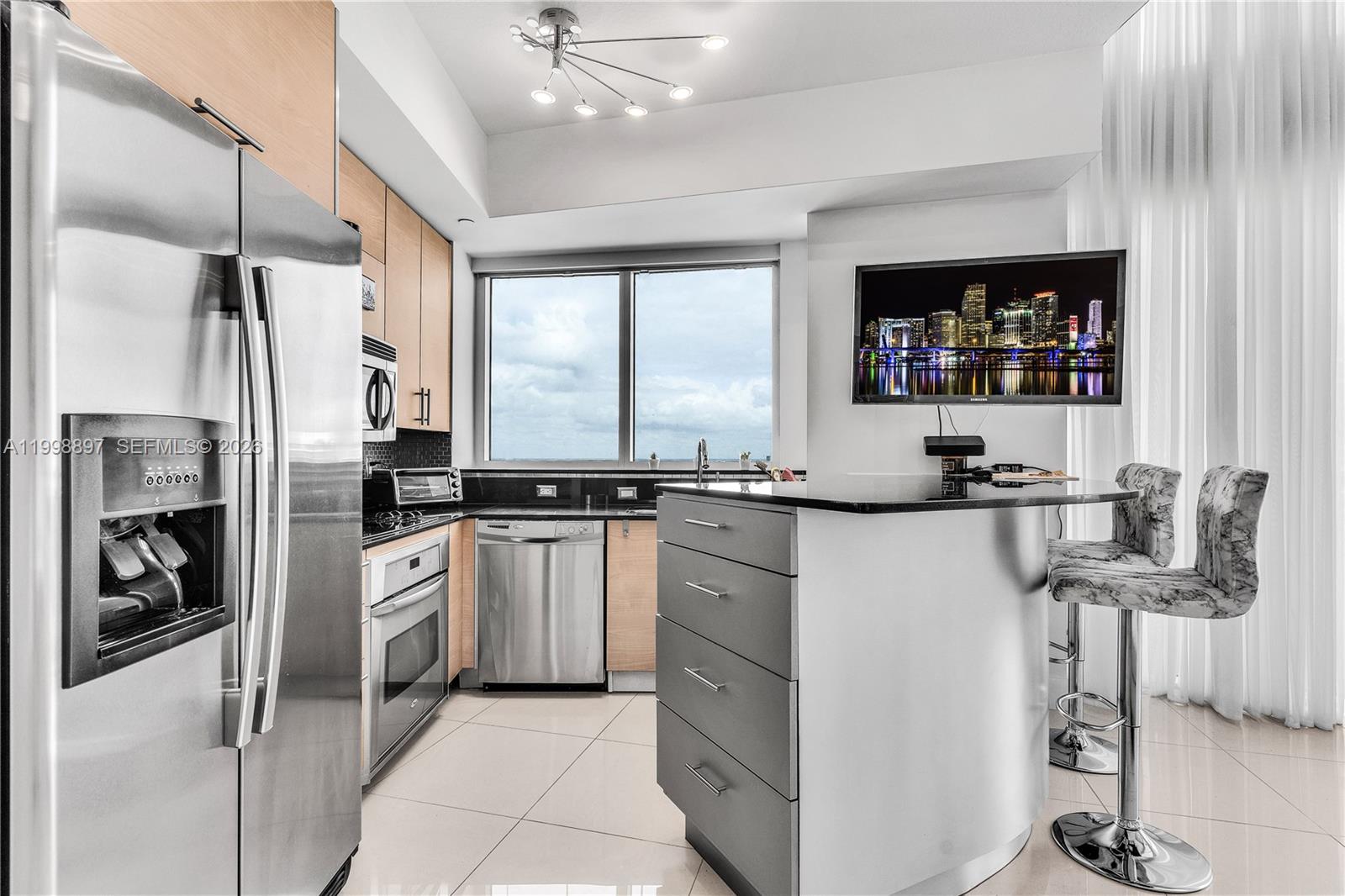 60 Southwest 13th Street, Unit 4818 Miami, FL 33130 - Photo 7 of 19 a kitchen with a refrigerator and a sink