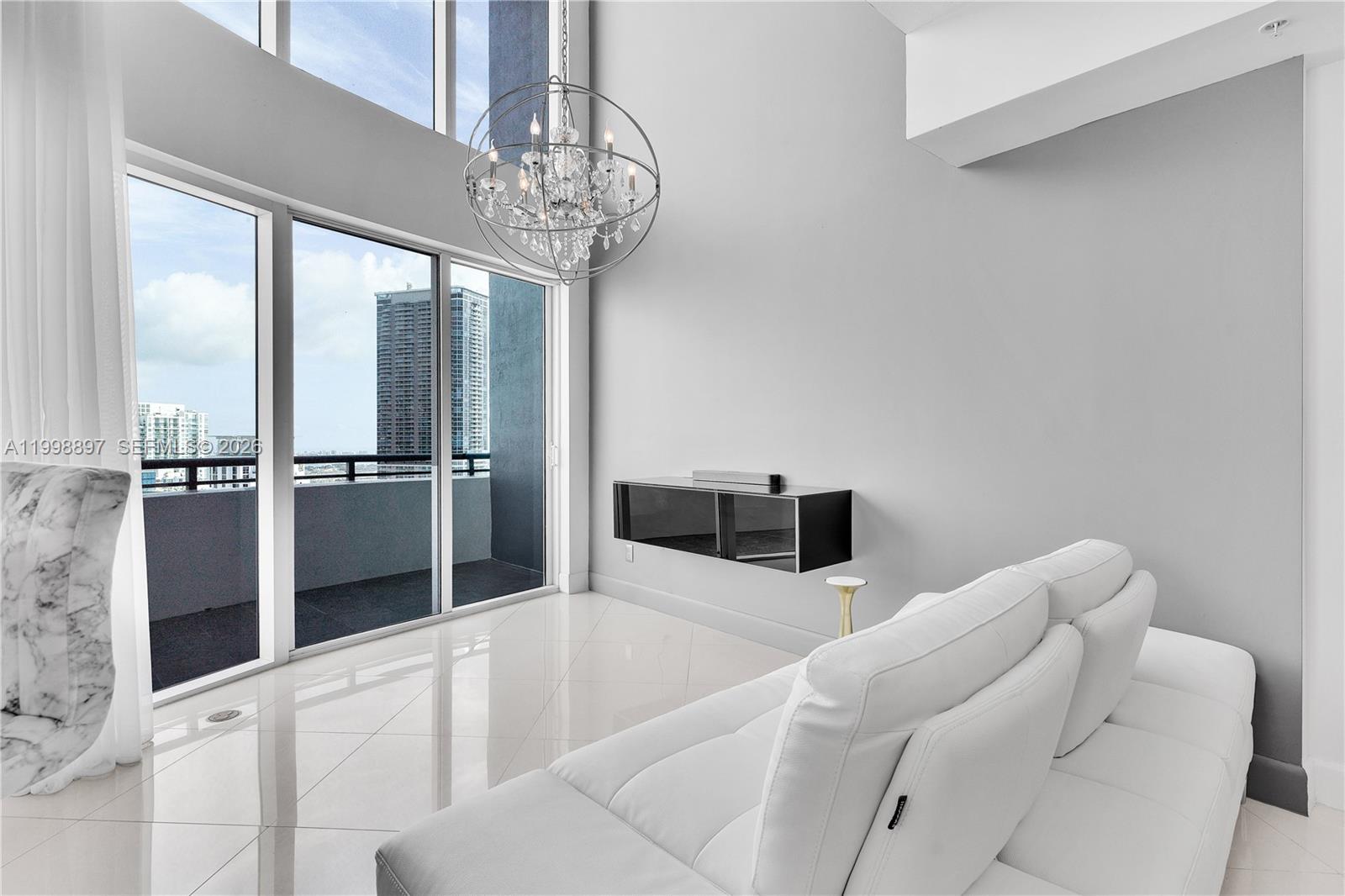 60 Southwest 13th Street, Unit 4818 Miami, FL 33130 - Photo 8 of 19 a living room with furniture and a chandelier
