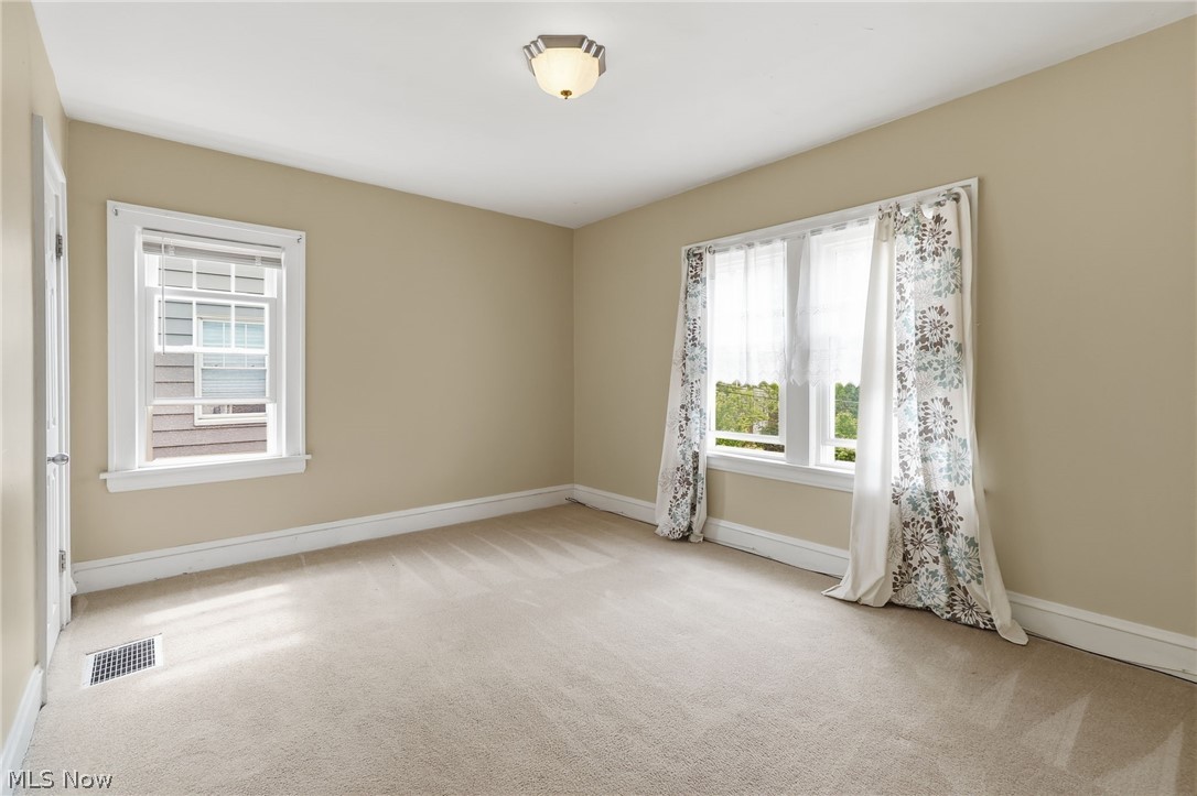 3511 Northcliffe Road Cleveland, OH 44118 - Photo 24 of 46 Bright, light-filled bedroom featuring neutral wall finishes, wall-to-wall carpeting, and dual windows with natural light