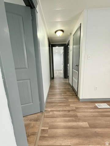 2491 Highway 89, Unit 114 Pleasant View, UT 84404 - Photo 15 of 18 Hall featuring wood finished floors and a textured ceiling