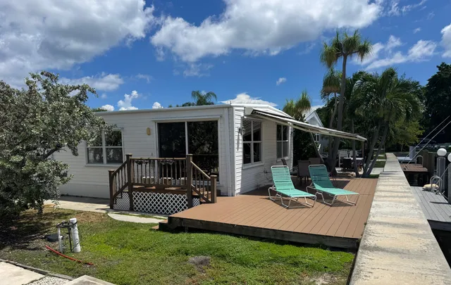 a view of a house with backyard porch and sitting area