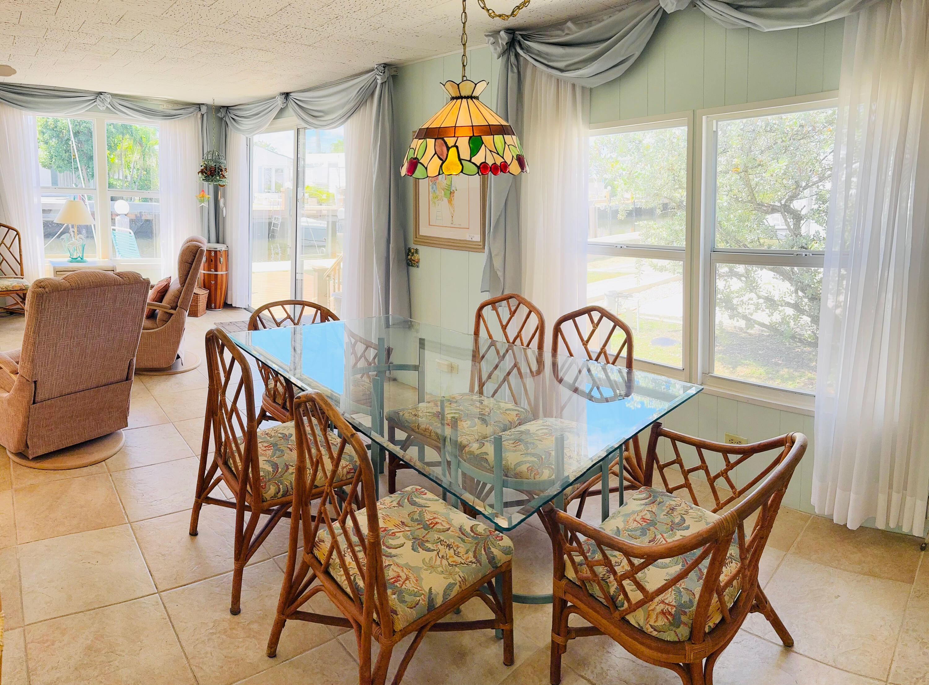 205 South Ibis Drive, Unit R Briny Breezes, FL 33435 - Photo 12 of 38 a dining room with furniture and a floor to ceiling window