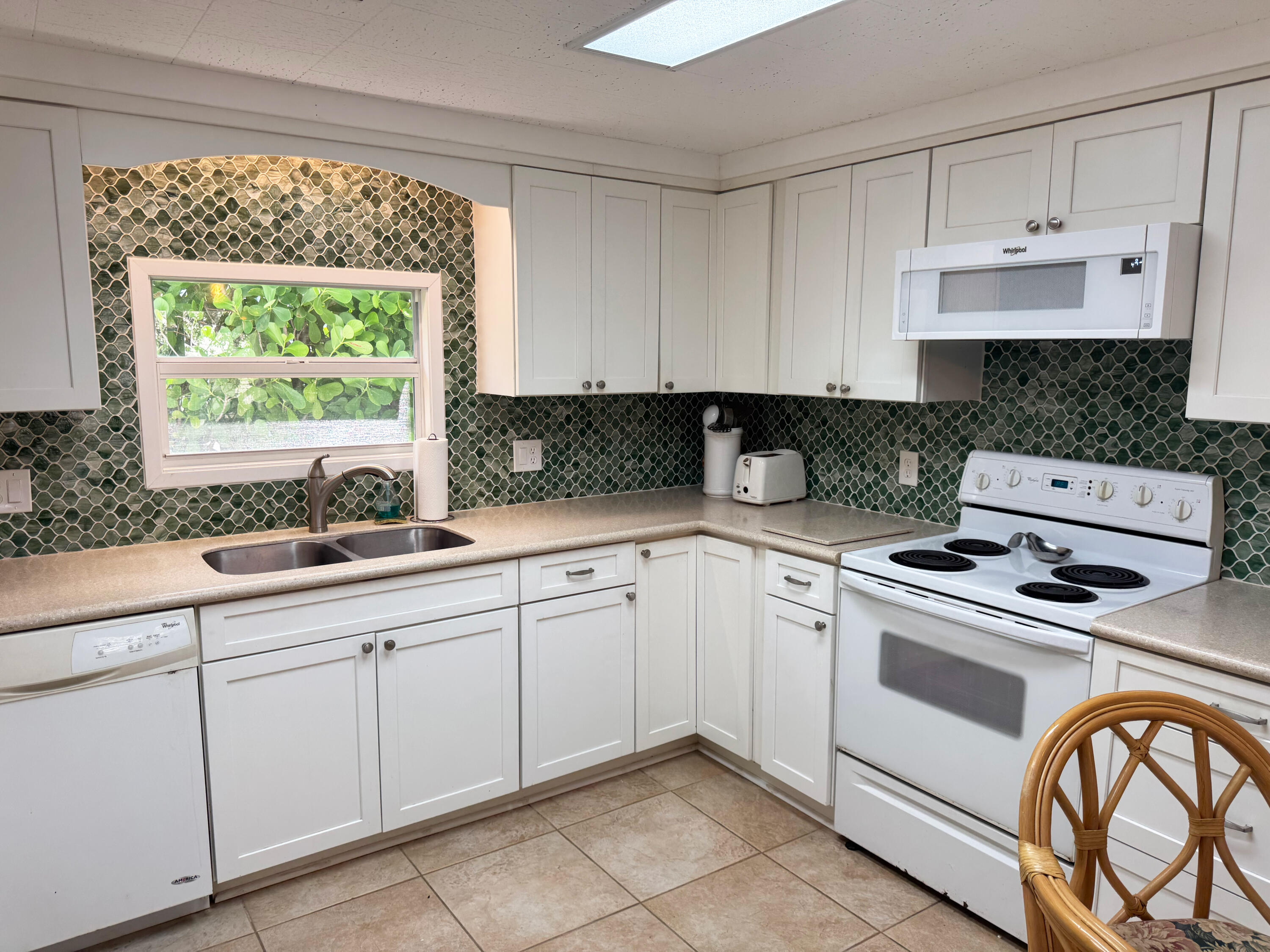 205 South Ibis Drive, Unit R Briny Breezes, FL 33435 - Photo 16 of 38 a kitchen with white cabinets white stainless steel appliances and sink