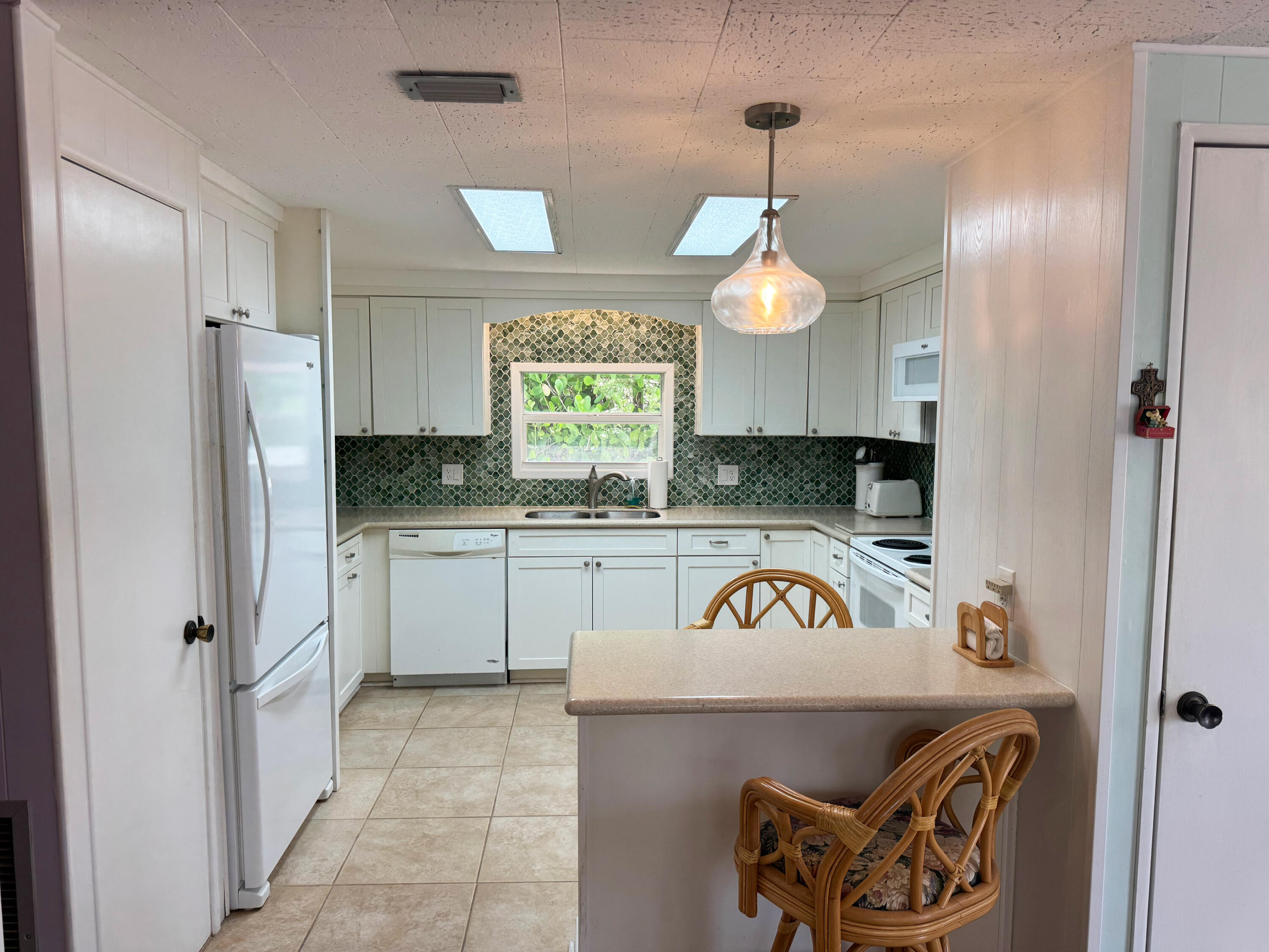 205 South Ibis Drive, Unit R Briny Breezes, FL 33435 - Photo 17 of 38 a kitchen with a refrigerator and a sink