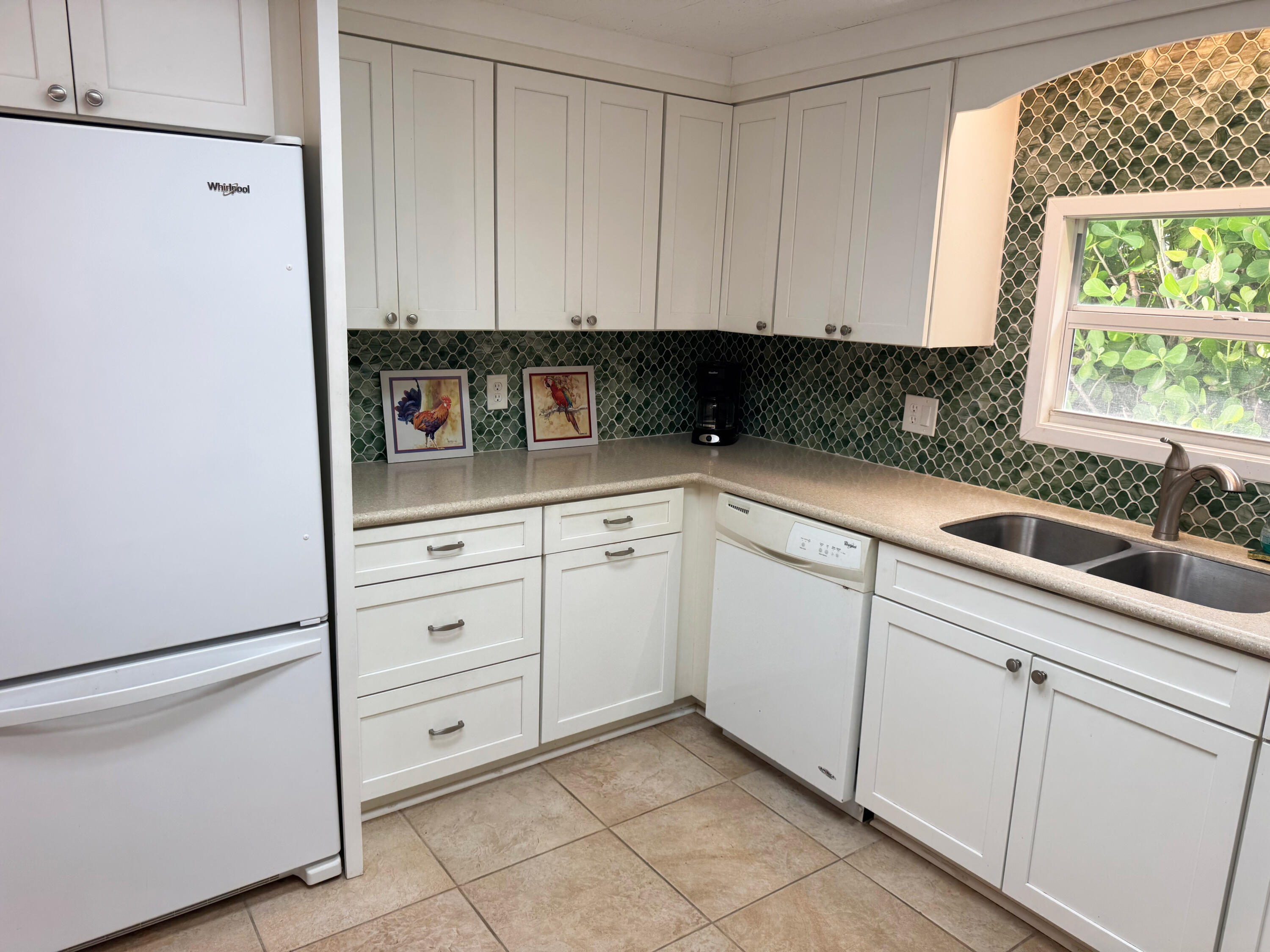 205 South Ibis Drive, Unit R Briny Breezes, FL 33435 - Photo 18 of 38 a kitchen with white cabinets and window