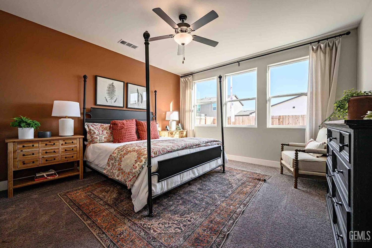 Undisclosed Address Bakersfield, CA 93313 - Photo 11 of 27 a bedroom with a bed and a chandelier