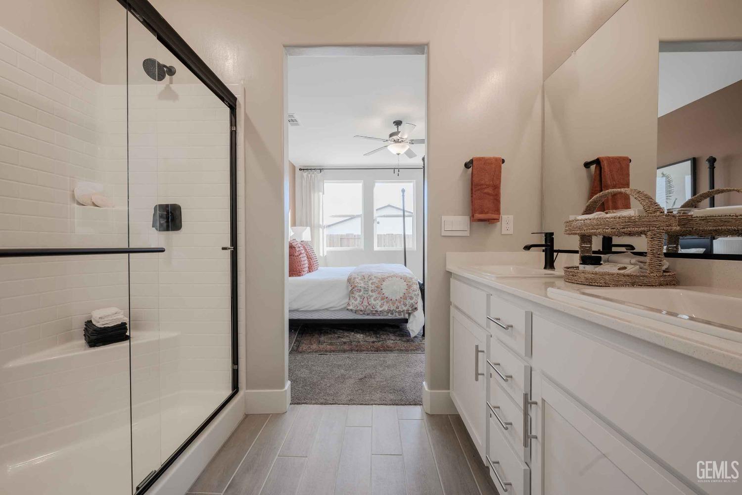 Undisclosed Address Bakersfield, CA 93313 - Photo 14 of 27 a en suite bathroom with a tub shower and mirror