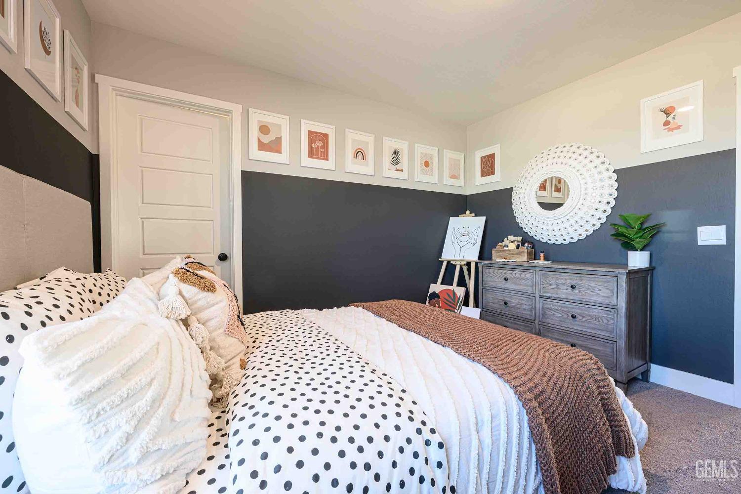 Undisclosed Address Bakersfield, CA 93313 - Photo 18 of 27 a bedroom with a bed and a chandelier