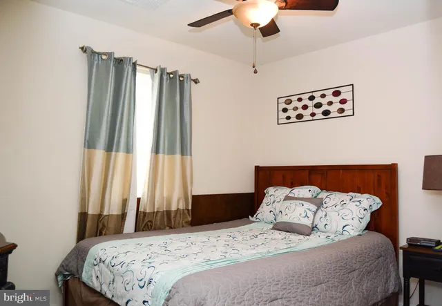 a bedroom with a bed and a dresser