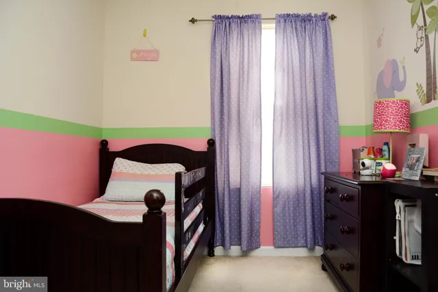 a bathroom with a toilet and a shower curtain