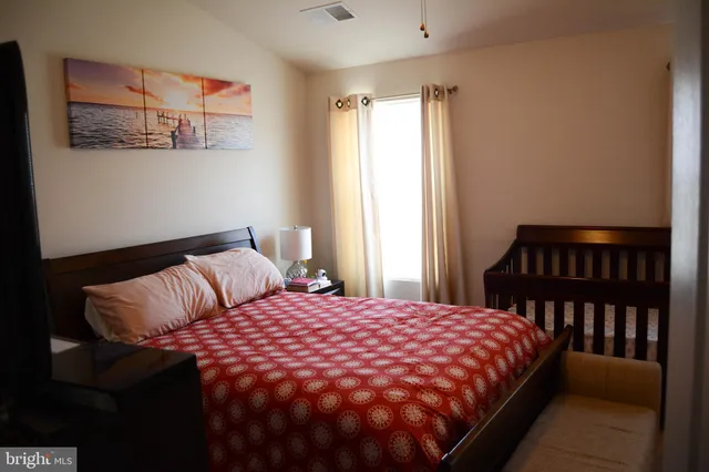 a bedroom with a bed and a window