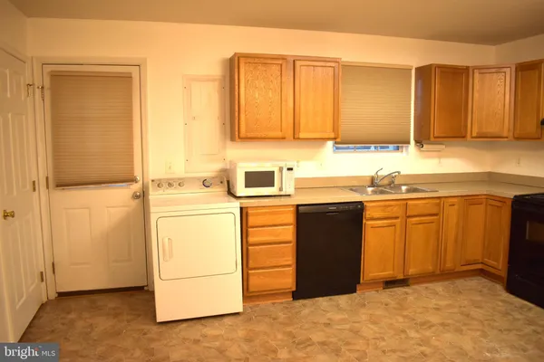 a kitchen with a sink and a refrigerator