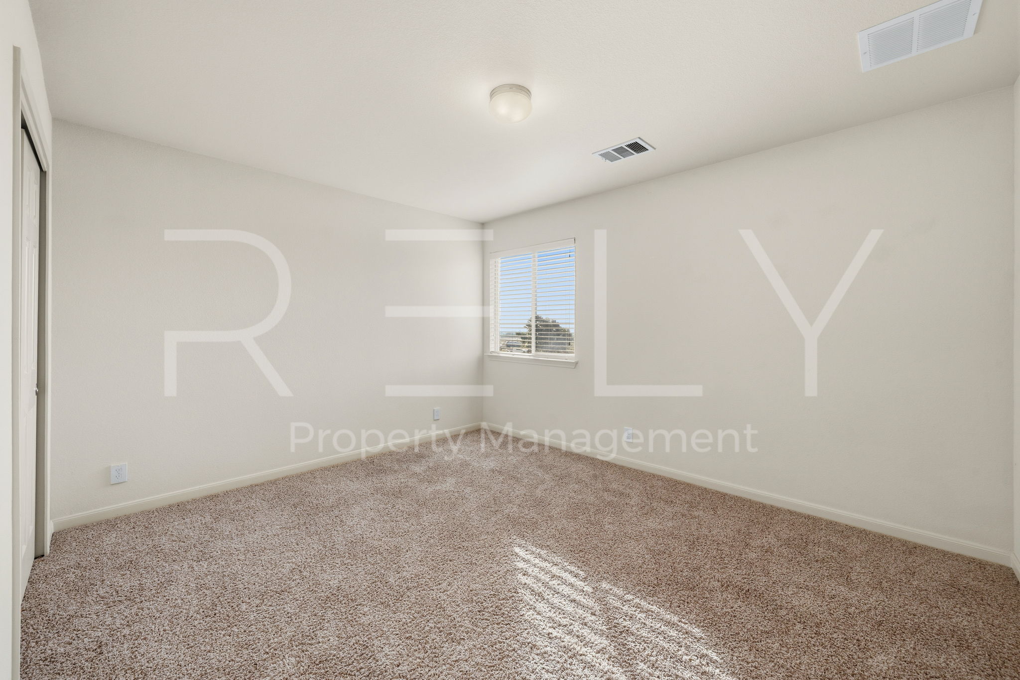 1405 Sunny Meadows Loop Georgetown, TX 78626 - Photo 28 of 40 A well-lit bedroom offering a cozy retreat with soft carpeting and natural light.
