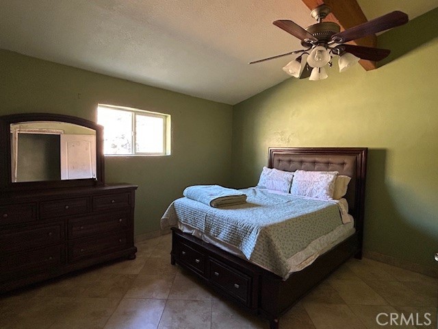 31163 Villa Nova Road Lucerne Valley, CA 92356 - Photo 9 of 25 a bedroom with a bed and a chandelier
