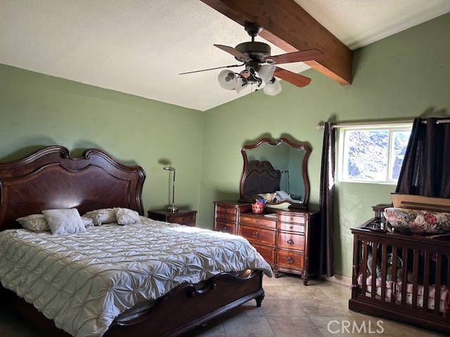 31163 Villa Nova Road Lucerne Valley, CA 92356 - Photo 10 of 25 a bedroom with a bed and a chandelier