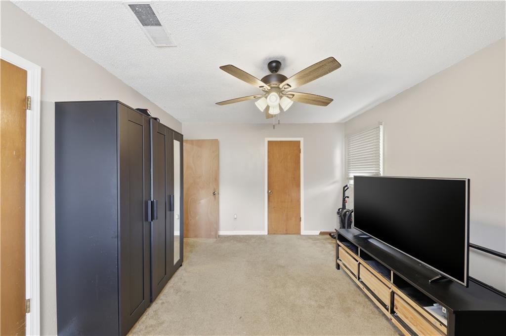 9 Belmonte Court Southwest Atlanta, GA 30311 - Photo 8 of 13 a living room with a flat screen tv and a ceiling fan