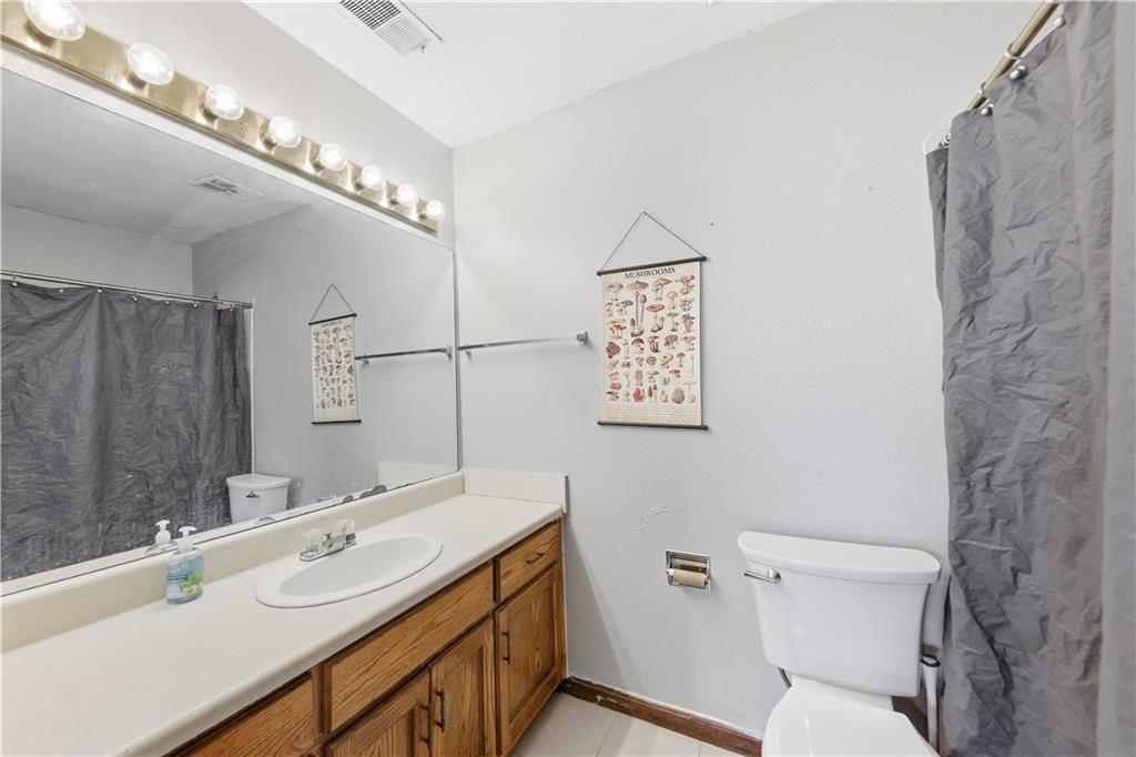9 Belmonte Court Southwest Atlanta, GA 30311 - Photo 9 of 13 a bathroom with a double vanity sink mirror and toilet