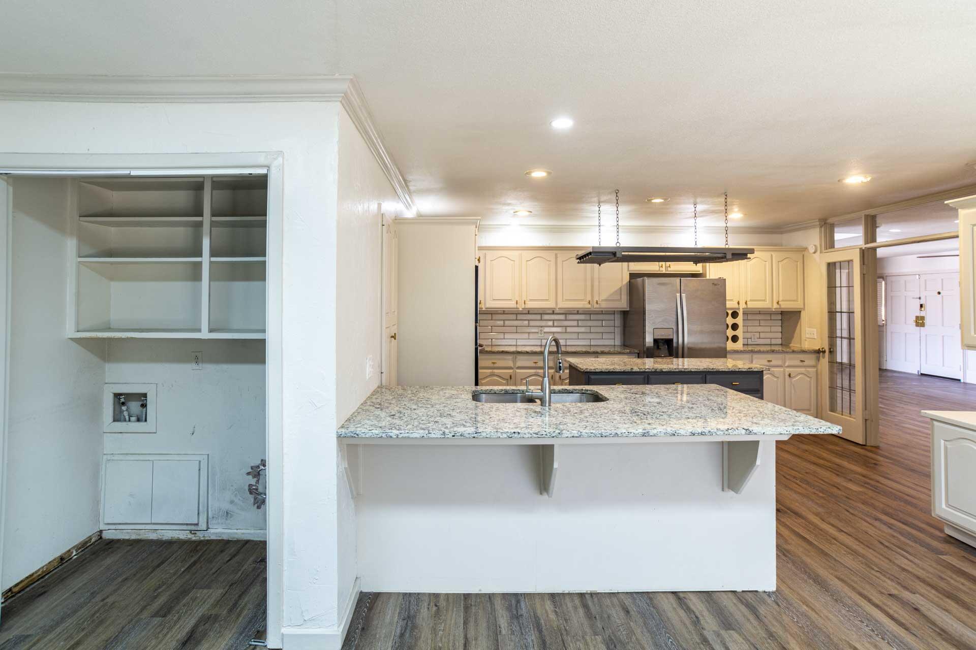 2136 57th Street Lubbock, TX 79412 - Photo 13 of 41 a large kitchen with stainless steel appliances granite countertop a sink and a stove