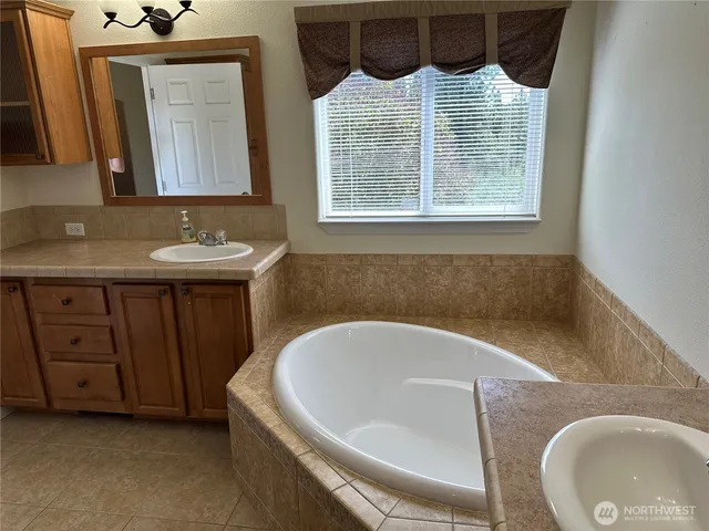 a bedroom with a bed and a mirror