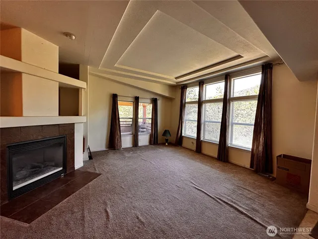 a view of an empty room with a fireplace