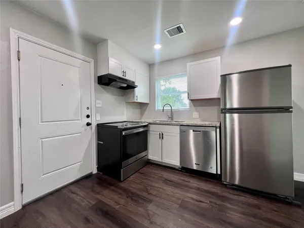 a kitchen with stainless steel appliances a refrigerator sink and microwave