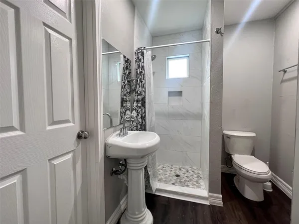 a bathroom with a sink toilet and shower