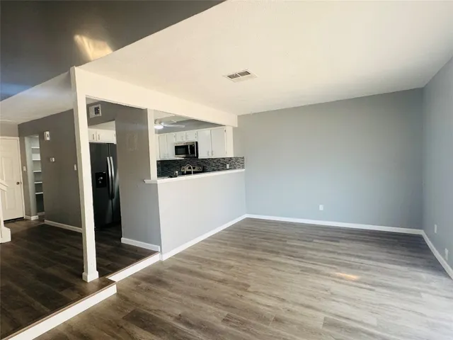 a view of a kitchen with wooden floor and a kitchen