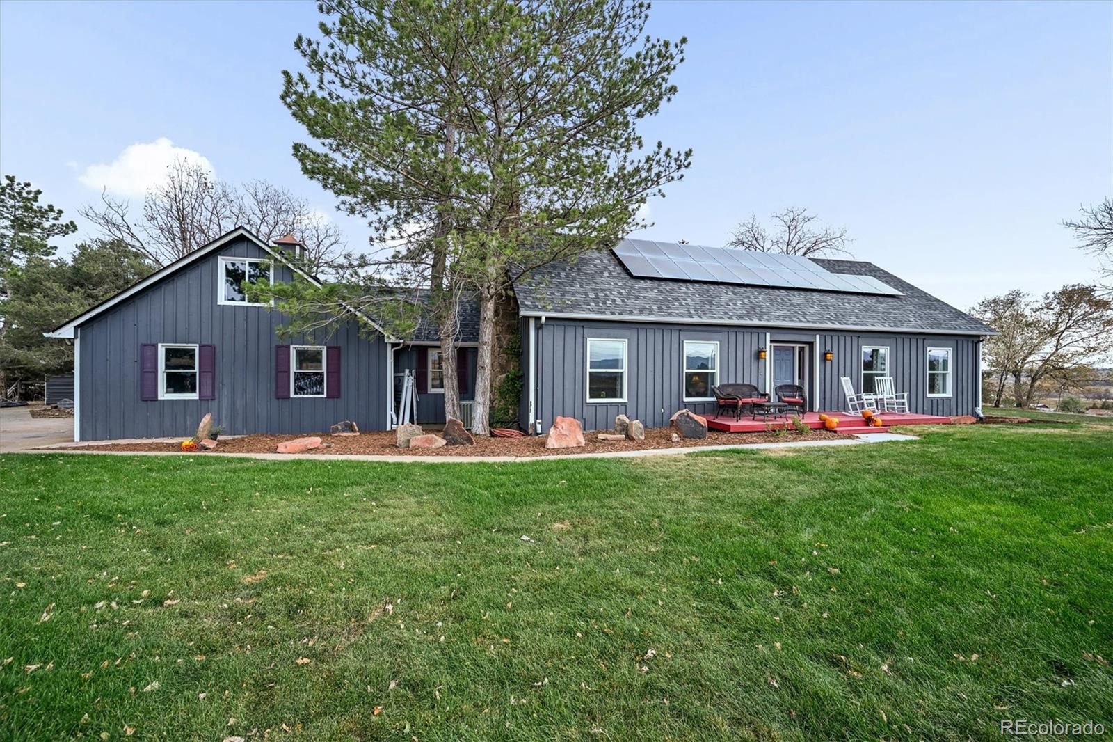 a front view of a house with swimming pool having outdoor seating
