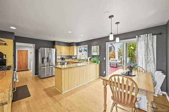 a kitchen with stainless steel appliances granite countertop a sink a stove and a counter space